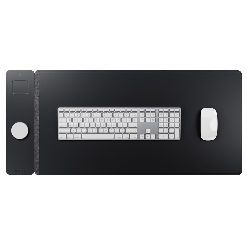 Black desk mat with keyboard and mouse on a white background