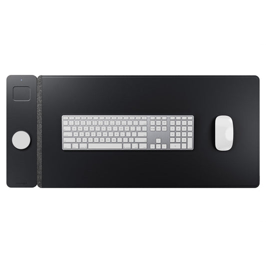 Black desk mat with keyboard and mouse on a white background
