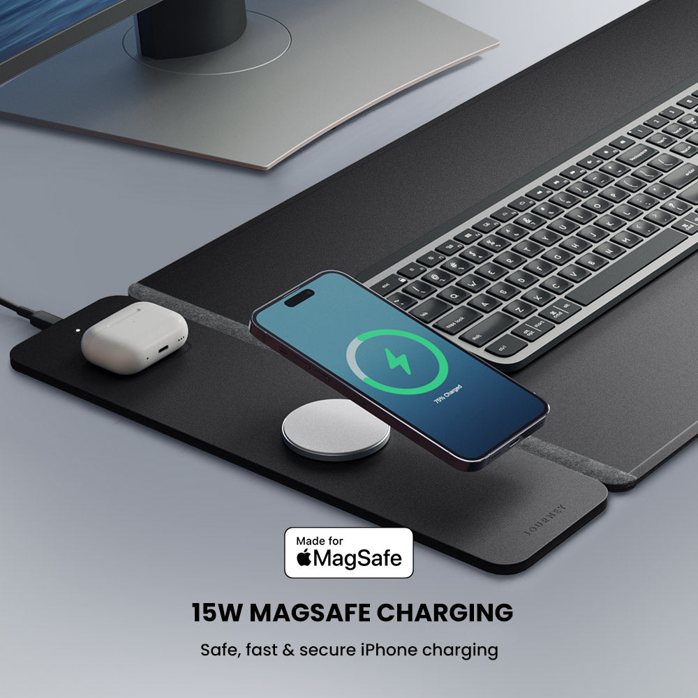 Smartphone with MagSafe charger on a desk with keyboard and mouse