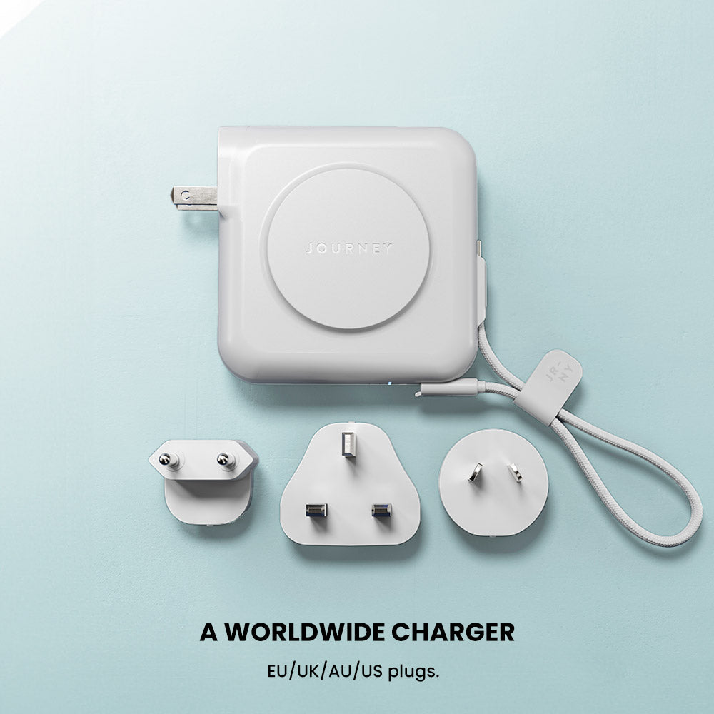 Worldwide charger with multiple plug adapters on a light blue background
