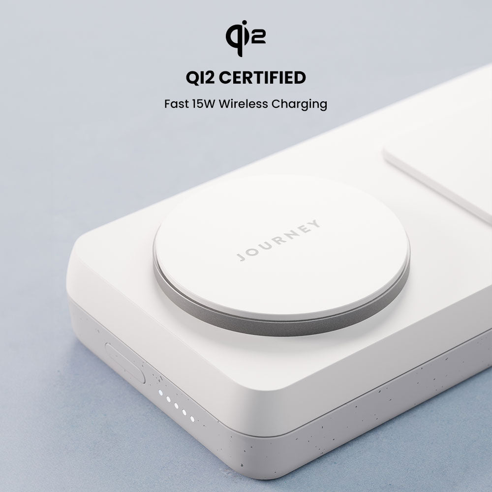Wireless charging pad with QI2 certification on a light gray background