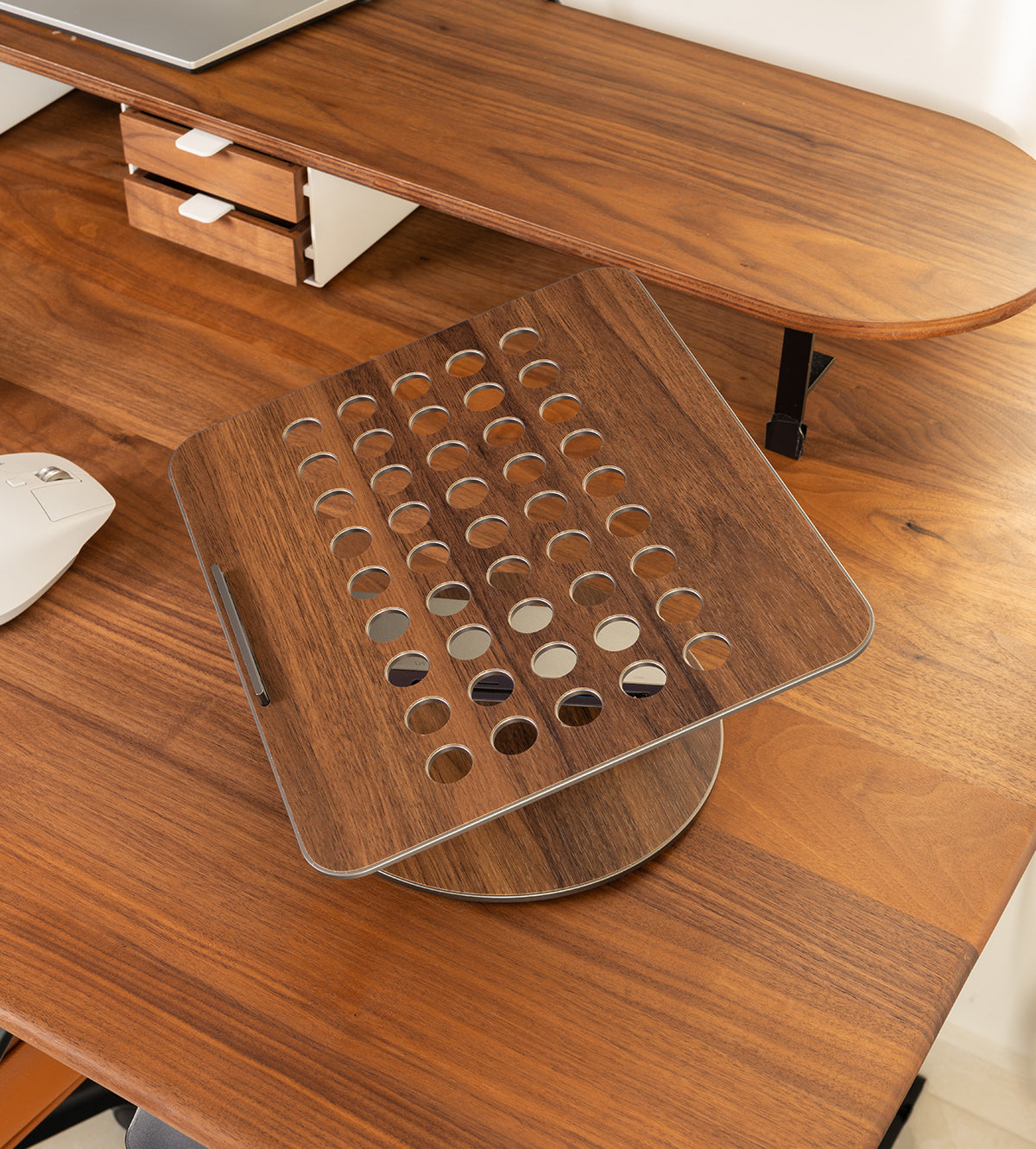 Wooden desk with a transparent laptop stand on a wooden desk