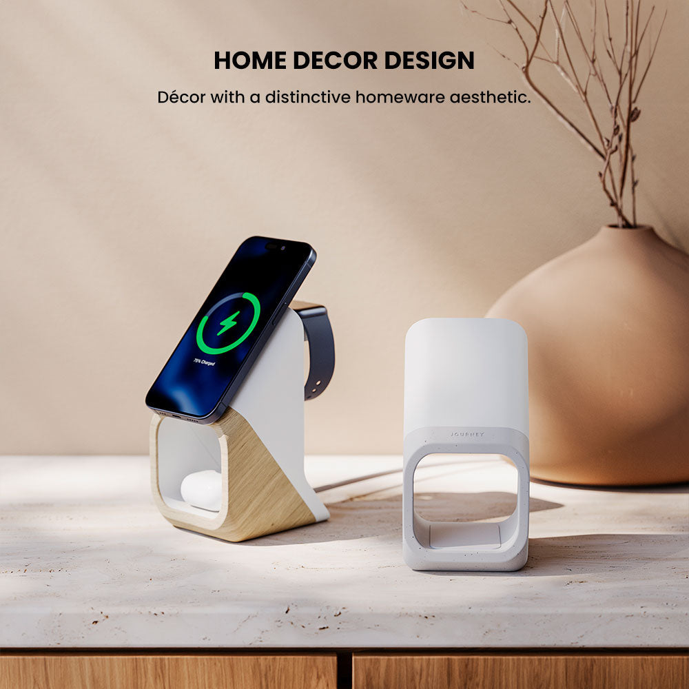 Wireless charging station with smartphone, smartwatch, and white speaker on a wooden surface with a vase in the background.