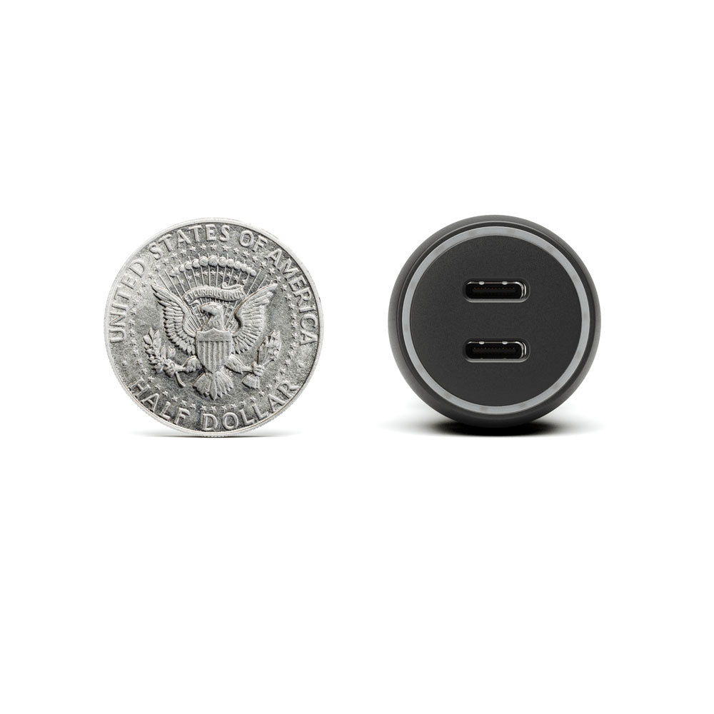 Silver coin and black USB-C charging adapter on a white background
