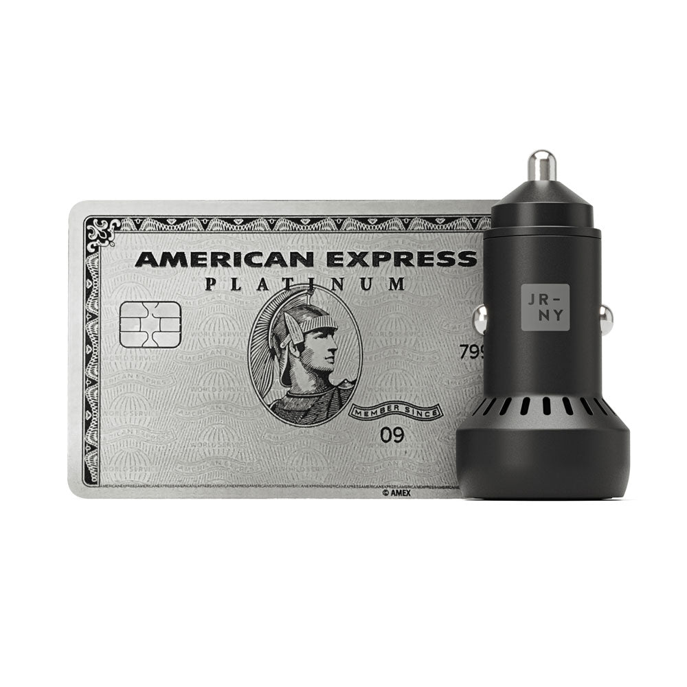 American Express Platinum card and black car charger on a white background