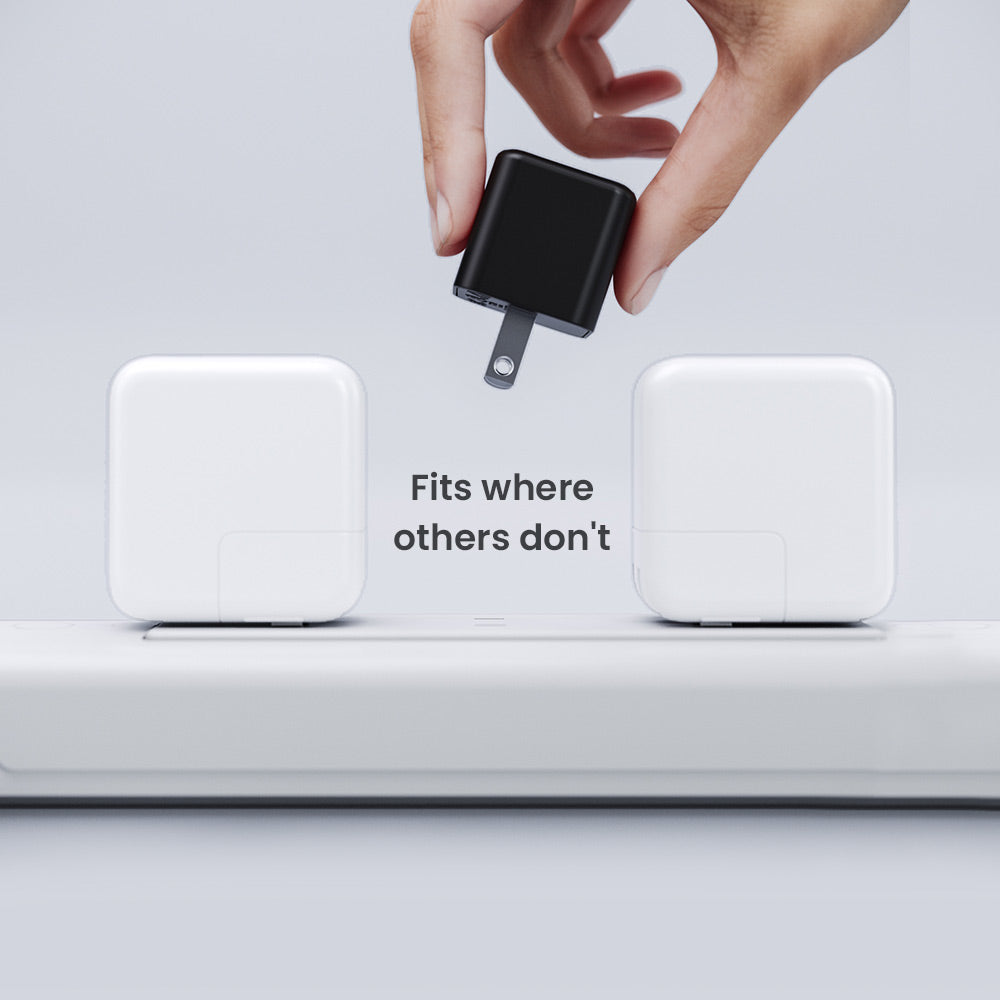 Black adapter being plugged into a white device with text 'Fits where others don't' on a light gray background.