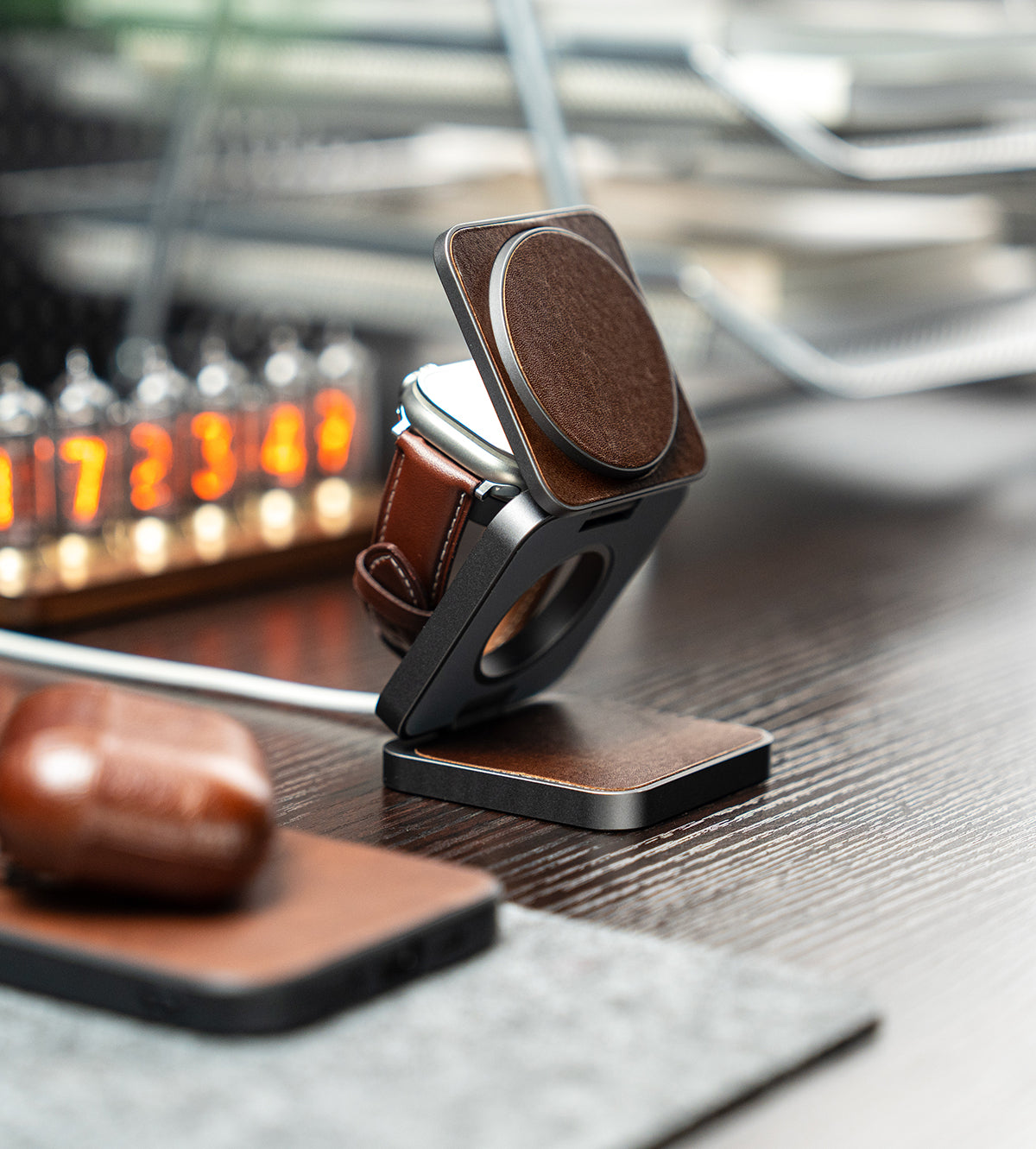 Phone stand with leather accents on a wooden surface