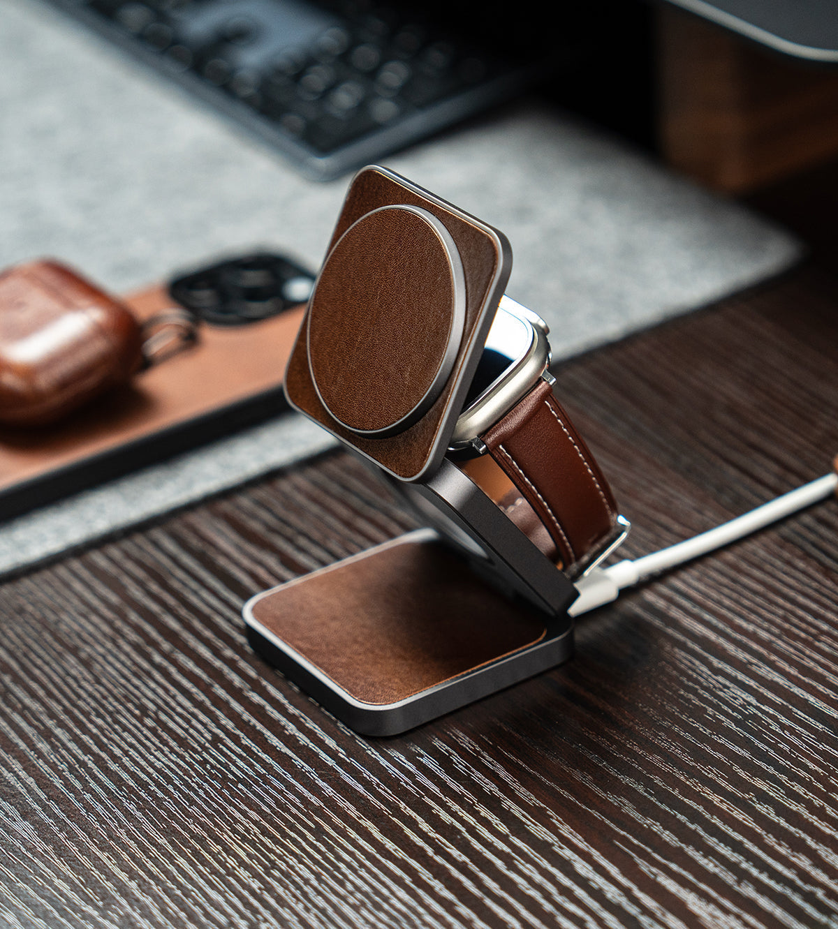 Brown leather belt with a silver buckle on a wooden surface