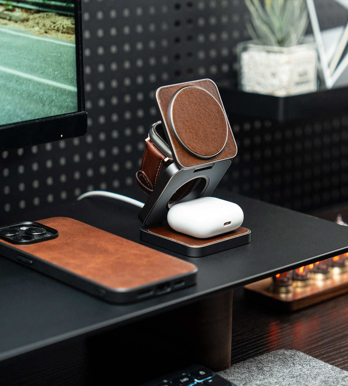 Phone case, phone, and wireless charger on a desk with a blurred background
